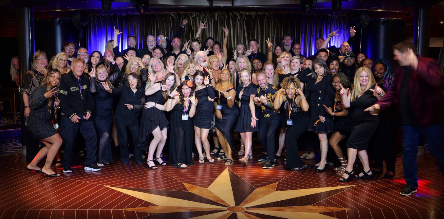 Dreamers Cruise guests dressed in black celebrating together